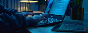 a person typing on a laptop with the sam registration website open on the screen.